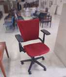 Rolling Office Chair. A red fabric seat with black adjustable arms and legs