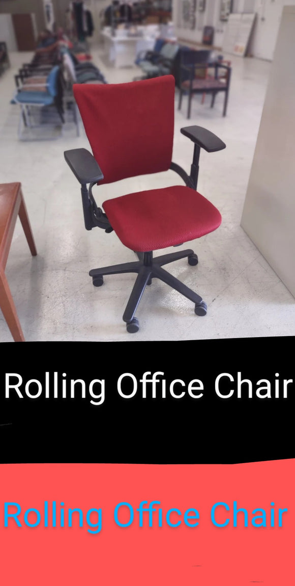 Rolling Office Chair. A red fabric seat with black adjustable arms and legs